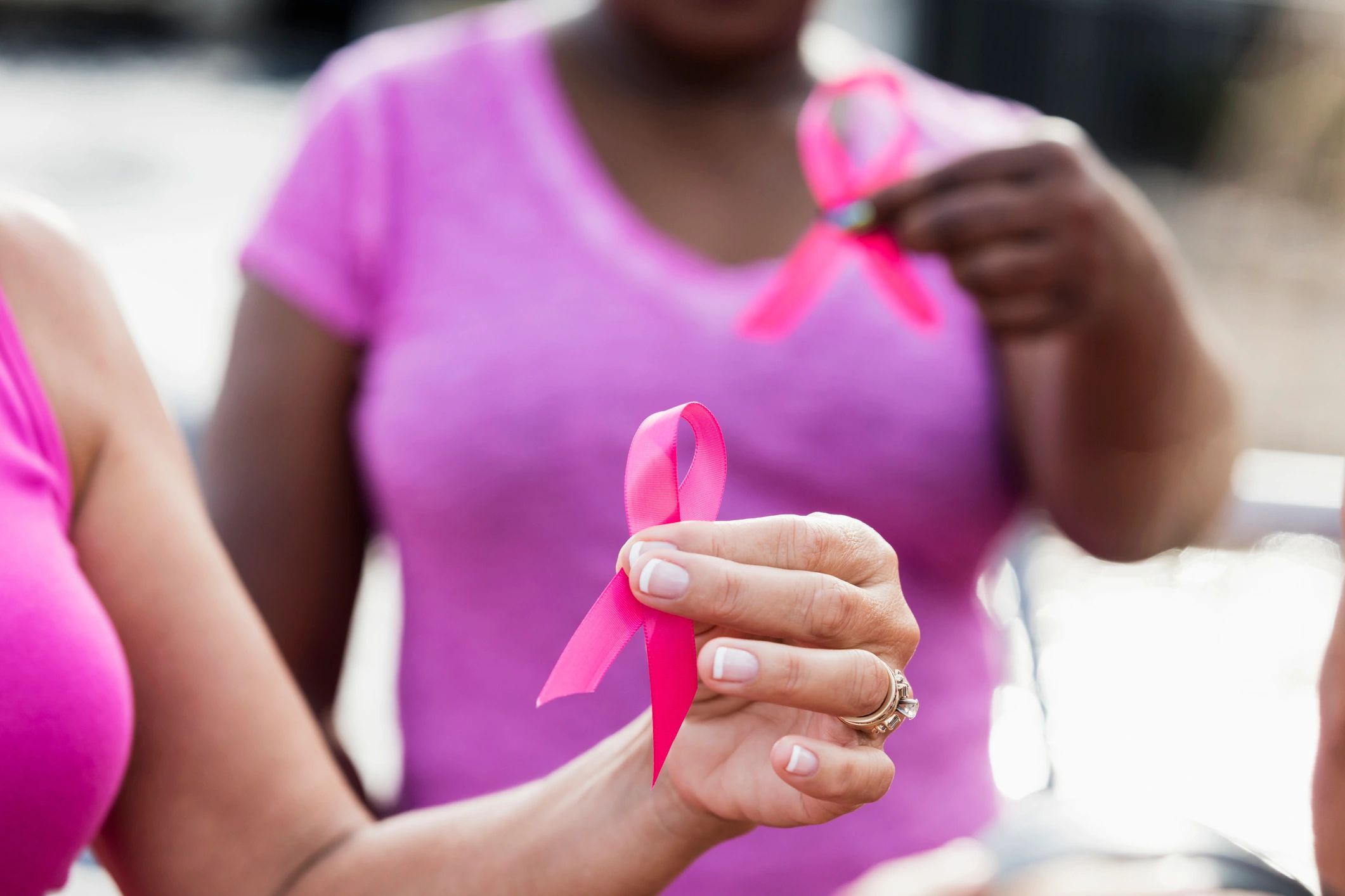 Multi-ethnic women with breast cancer awareness ribbons