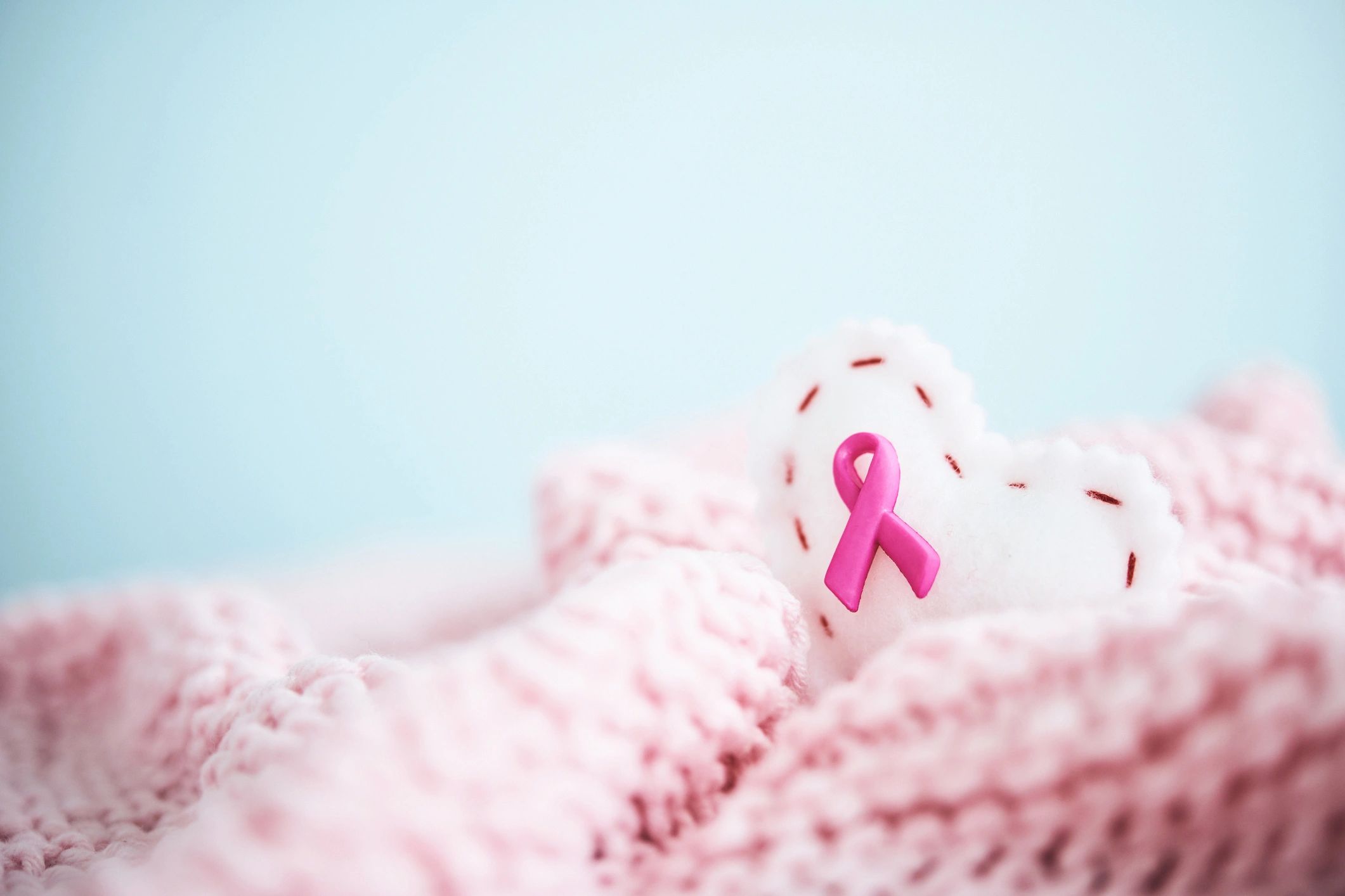 Pink breast cancer awareness ribbon on a handmade blanket