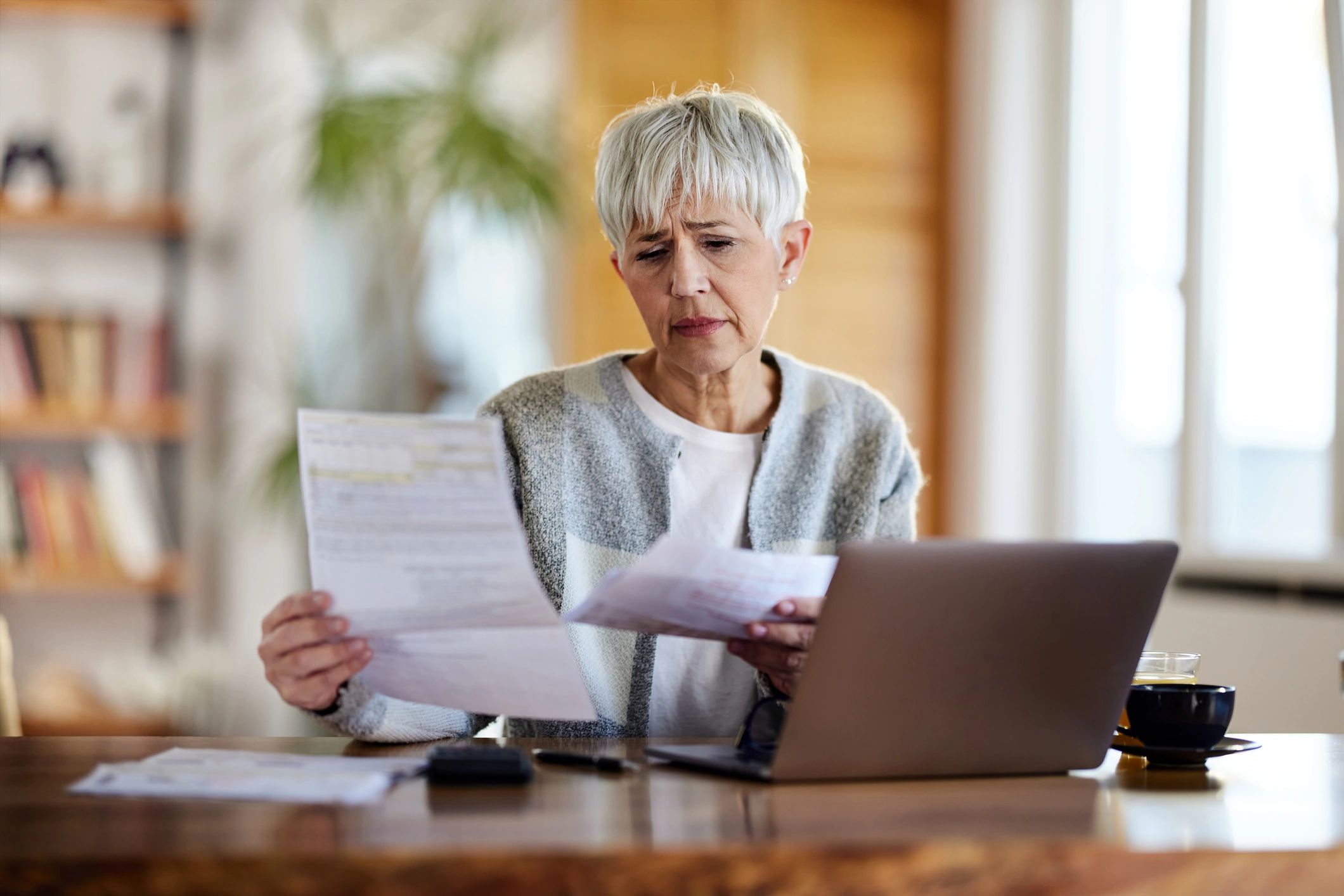 Patient reviewing bills and paperwork at home